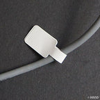 Close-up of white tag labels for jewellery pricing on a sheet