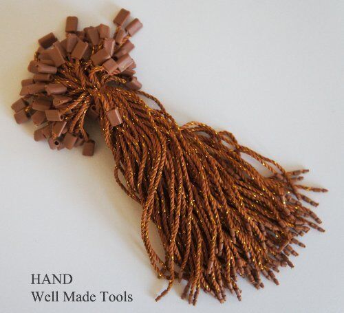 Brown nylon string round snap lock hang tags with gold trim.