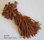 Brown nylon string round snap lock hang tags with gold trim.