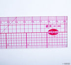 Flexible grader ruler being used to measure a clothing pattern.