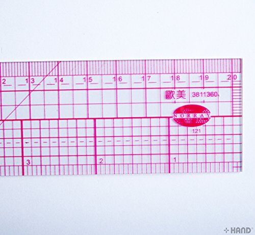 Flexible grader ruler being used to measure a clothing pattern.