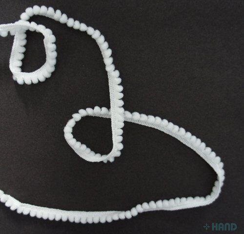 Close-up of 5mm white pom poms on 10mm wide trim