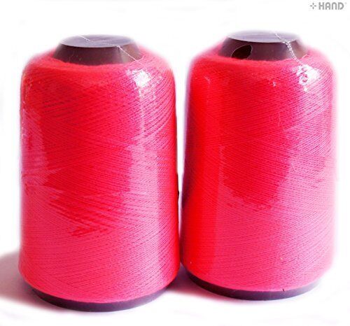 Two spools of neon pink sewing machine thread on a white background.