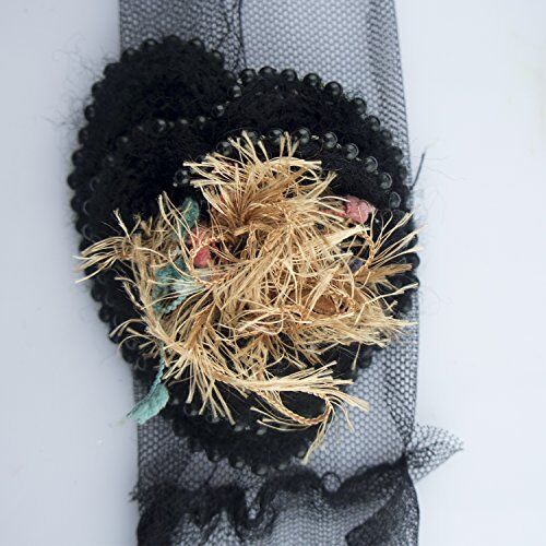 Detailed view of net backing on the decorative rosettes trim.