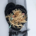 Detailed view of net backing on the decorative rosettes trim.