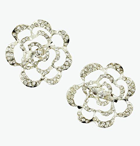 Two elegant clear crystal silver tone rose brooches displayed together.