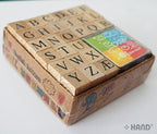 Close-up of a wooden rubber stamp featuring the letter A
