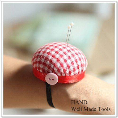 Red check wrist pin cushion on a sewing table