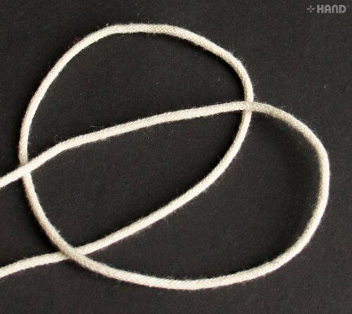 20 metres of cream thin string rope cord in a neat coil