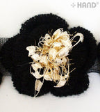 Tinsel net detail on the knitted flower trim