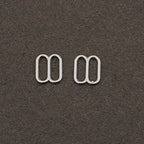 Pack of approximately 50 metal lingerie sliders displayed.