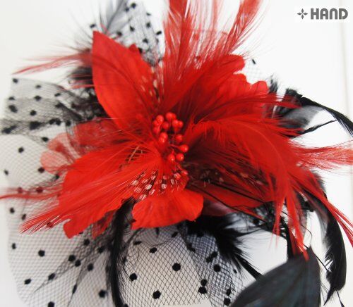 Close-up of a dotted feather flower brooch with metal pin