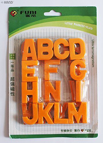 Magnetic alphabet letters arranged in a playful layout.