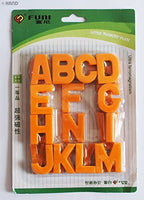 Magnetic alphabet letters arranged in a playful layout.