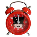 Red Soldier alarm clock with twin bells on a bedside table