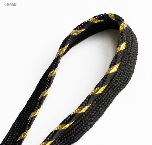 Close-up of 12mm wide black pipe trim with gold detailing