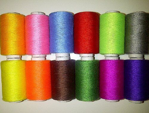 Close-up of assorted sewing thread spools in vibrant hues