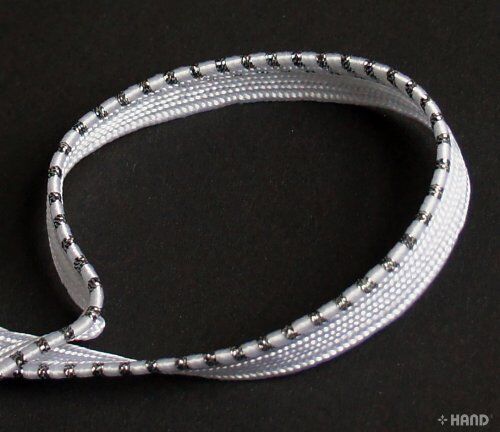Close-up of Silver Edge Sew in Pipe Trim in White and Silver