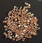 Flat lay of 2-part plain press studs in pale gold tone.