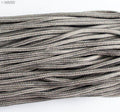 Dark green nylon string displayed with measuring tape