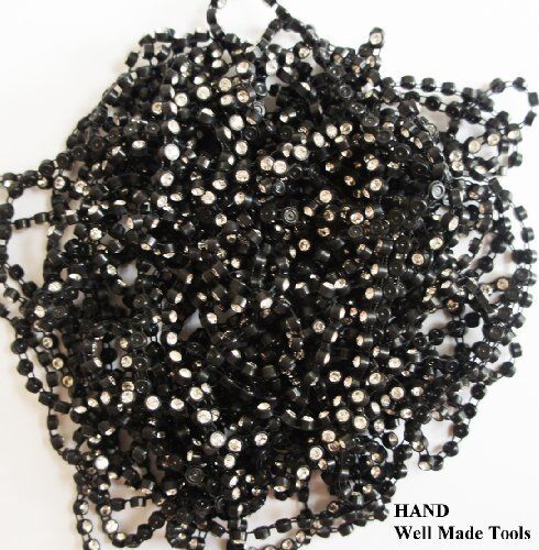 Application of black diamante trim on a garment for decoration
