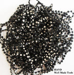 Close-up of black plastic cased diamante trim showing detail