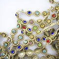 Gold tone garment trim with colourful crystals, 15 mm wide.