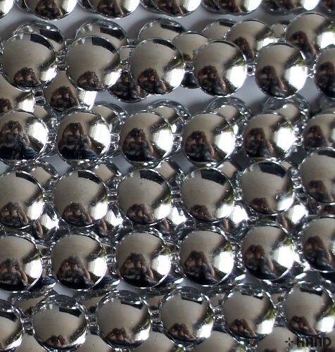 Close-up of Silver Flat Round Trims showing texture and shine.