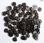 Close-up of dark copper snap studs in 21mm size