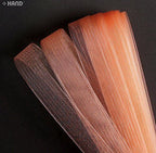 Roll of salmon pink nylon crin trim showing texture and colour