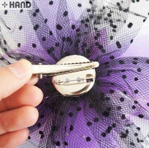 Close-up of beads and feathers on the millinery accessory