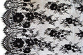 Close-up of NO.387 fine pattern wide corded lace in black