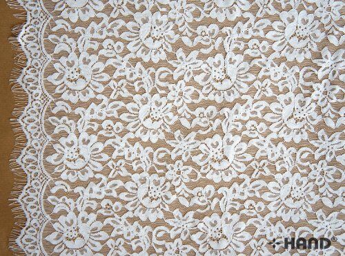 Close-up of the intricate design of the white corded lace.