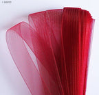 Ruby red nylon crin trim displayed on a white background.