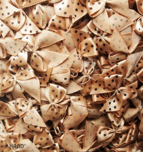 Close-up of a brown ribbon bow with black dots, showcasing its texture.
