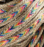 Close-up of colourful and brown plait belt trim on a white background.