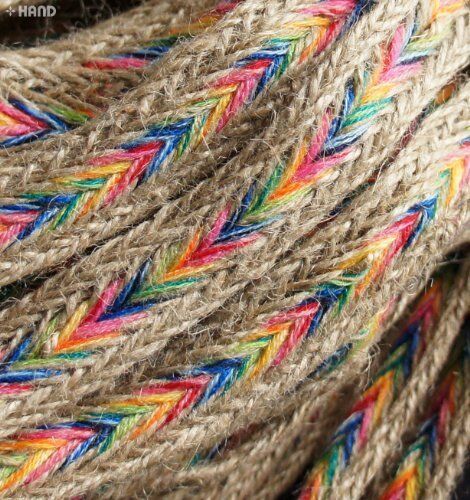 Close-up of colourful and brown plait belt trim on a white background.