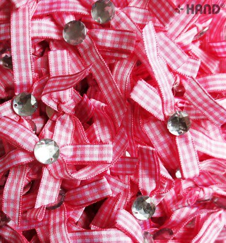 Close-up of a decorative pink and white bow with stone detail