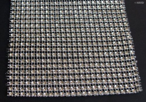 Close-up of gold diamante ribbon trim showcasing sparkle