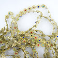 Gold tone trim with colourful crystals, 9mm wide.
