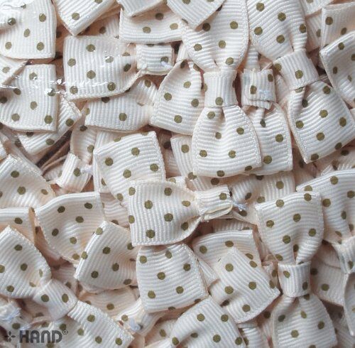 Close-up of cream ribbon bow showcasing brown dot design.