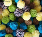 Assorted colours of 30mm decorative acrylic pom poms in a pack.