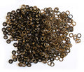 Close-up of vintage gold 10mm eyelets in a pack.