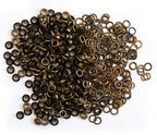 Close-up of vintage gold 10mm eyelets in a pack.