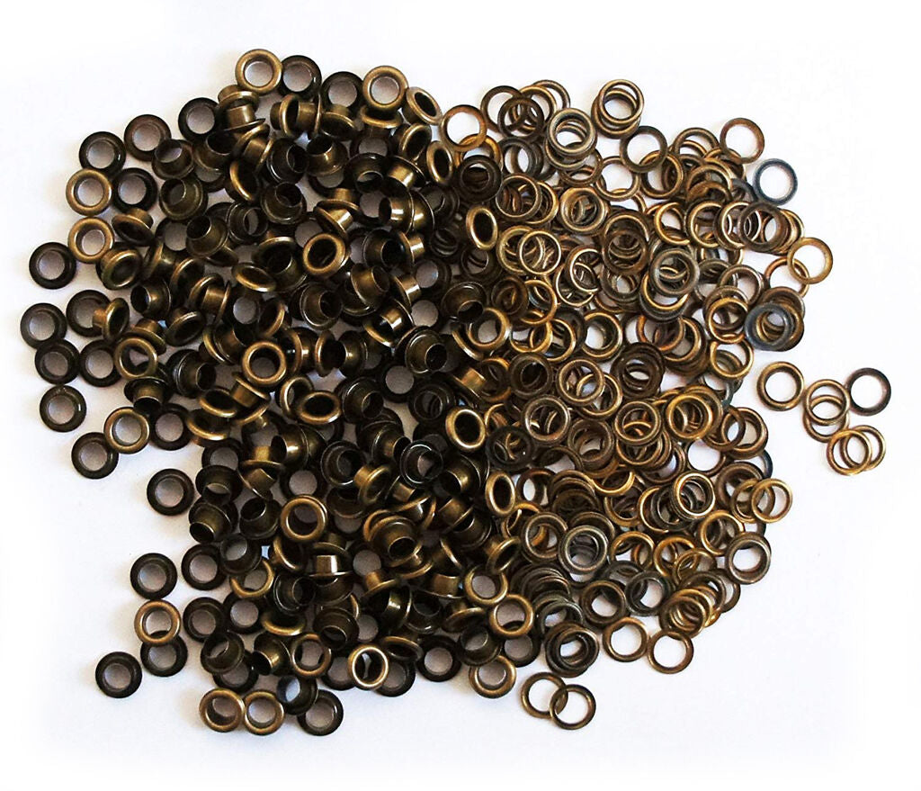 Close-up of vintage gold 10mm eyelets in a pack.