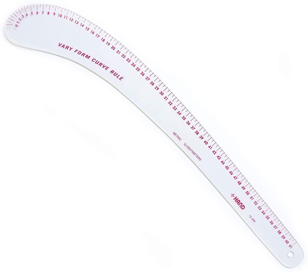 Flexible curve ruler laid flat on a crafting table