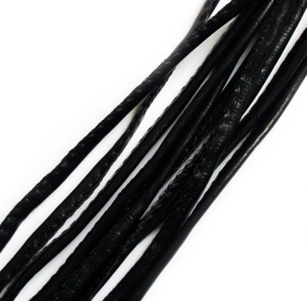 Close-up of black faux leather trim on a white background