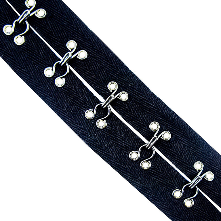 Close-up of hooks and eyes for corset making on a roll.