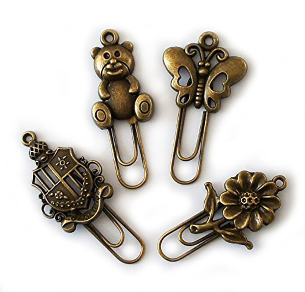 Four vintage gold metal bookmarks displayed together