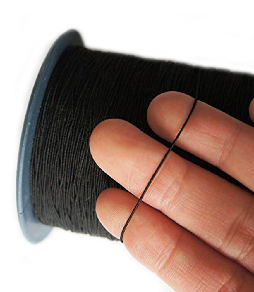 Large roll of black shirring elastic on a white background